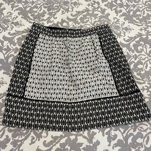 J. Crew, White and black print, mini skirt. Size 4. Exposed zipper in back.